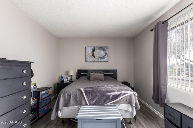 4240 N 67th Ln, Phoenix, AZ 85033 - bedroom with a textured ceiling, baseboards, and dark wood-style flooring