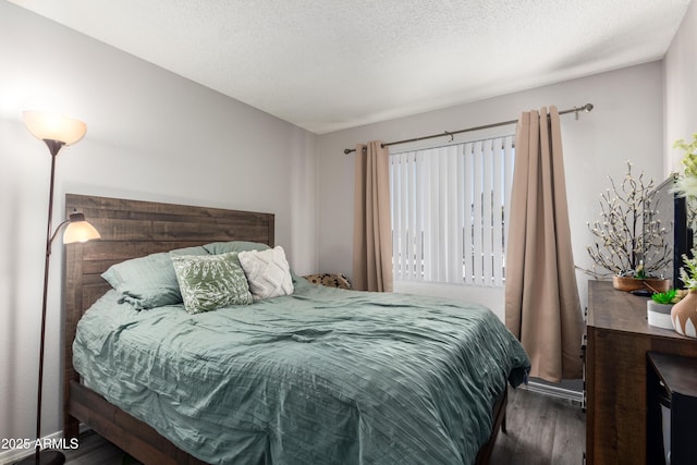 4240 N 67th Ln, Phoenix, AZ 85033 - bedroom with wood finished floors and a textured ceiling