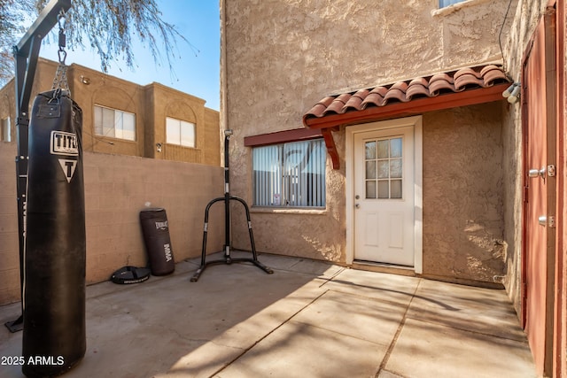 4240 N 67th Ln, Phoenix, AZ 85033 - doorway to property featuring fence, a patio area, and stucco siding