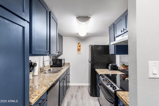 4240 N 67th Ln, Phoenix, AZ 85033 - kitchen featuring a sink, black appliances, light wood-style floors, baseboards, and under cabinet range hood