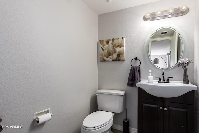 4240 N 67th Ln, Phoenix, AZ 85033 - half bathroom with toilet, vanity, and visible vents