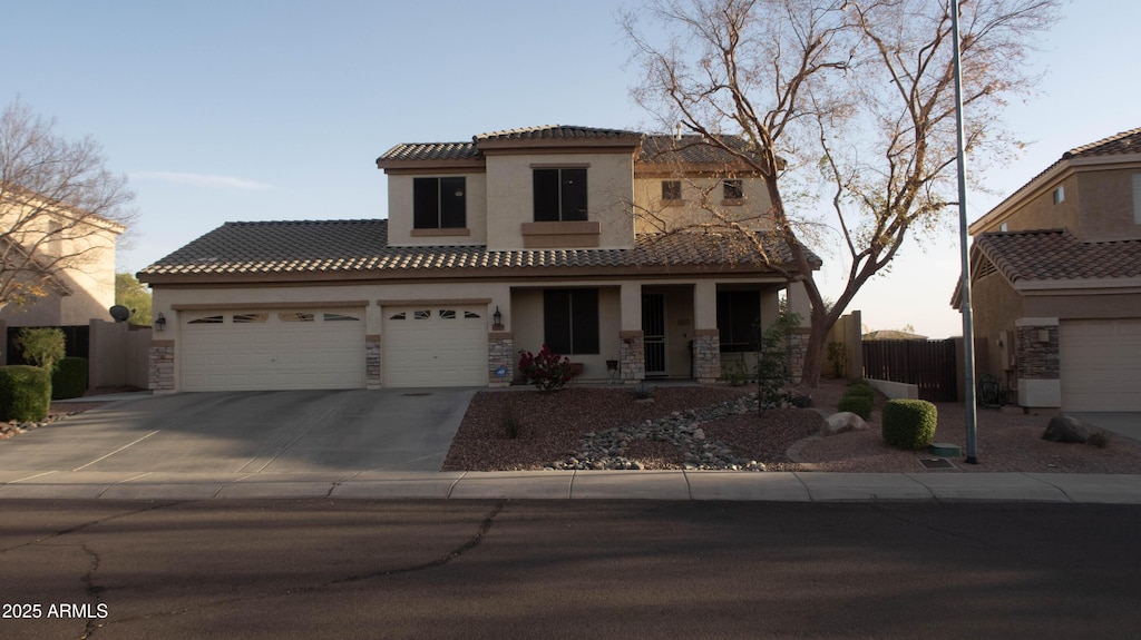 mediterranean / spanish-style house with a garage