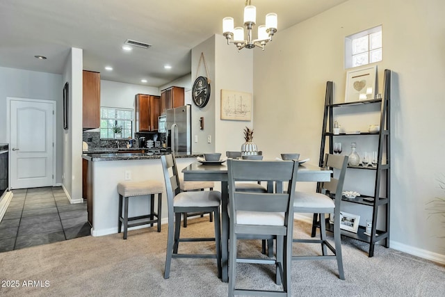 carpeted dining room with recessed lighting, visible vents, baseboards, and a chandelier