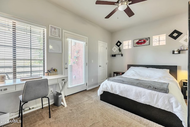 bedroom featuring baseboards, light colored carpet, a ceiling fan, and access to outside