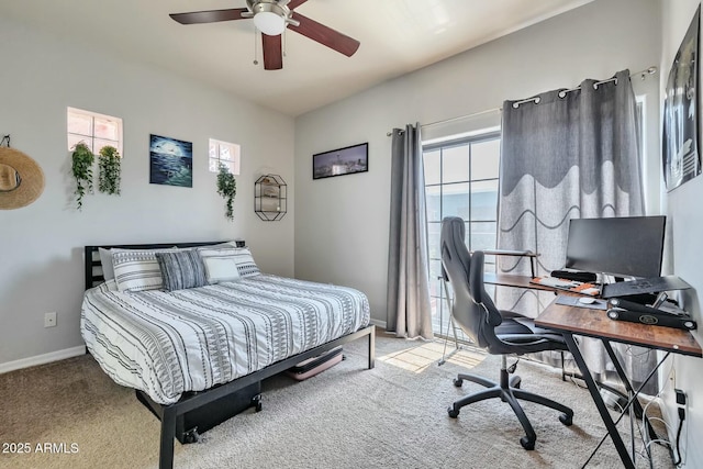 carpeted bedroom featuring a ceiling fan and baseboards