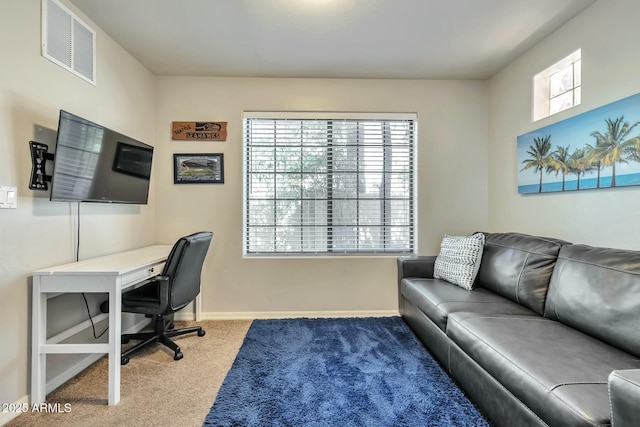 carpeted home office featuring visible vents and baseboards