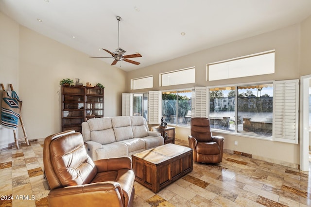 living room with ceiling fan and vaulted ceiling