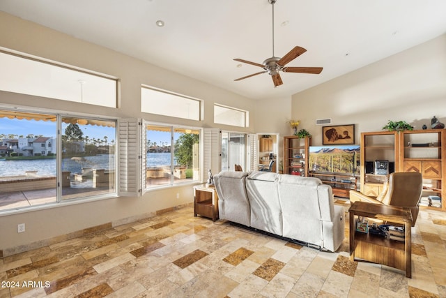 living room featuring a water view, high vaulted ceiling, and ceiling fan