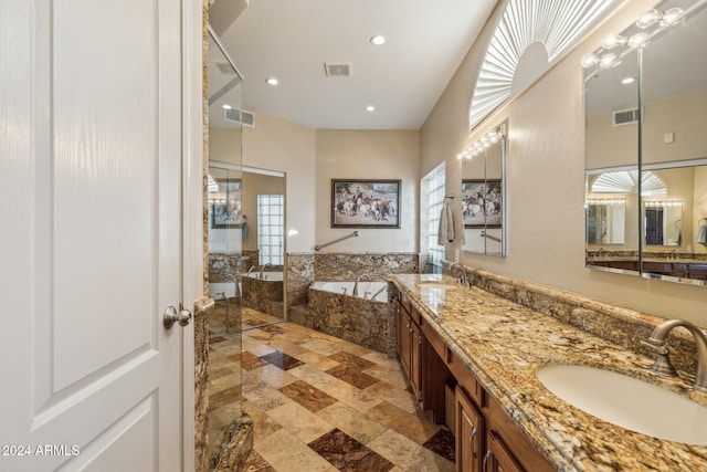 bathroom featuring vanity and tiled tub