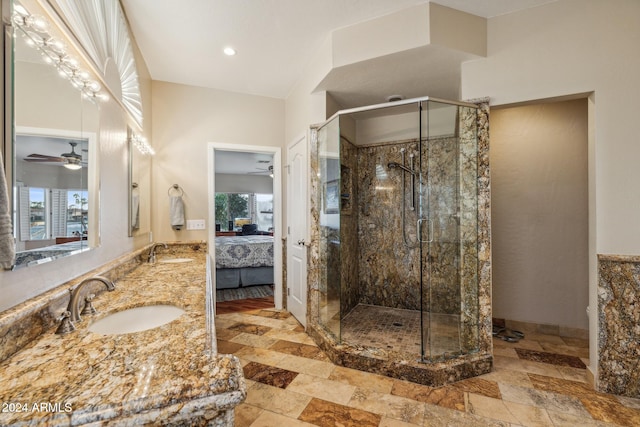 bathroom featuring vanity, ceiling fan, and a shower with shower door