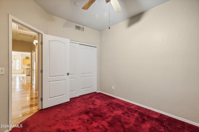 unfurnished bedroom featuring a closet, ceiling fan, and carpet