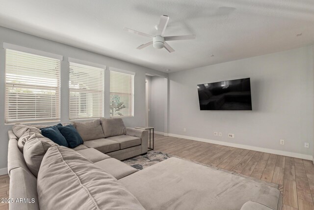 6931 W Spur Dr, Peoria, AZ 85383 - living area with wood finished floors, ceiling fan, and baseboards