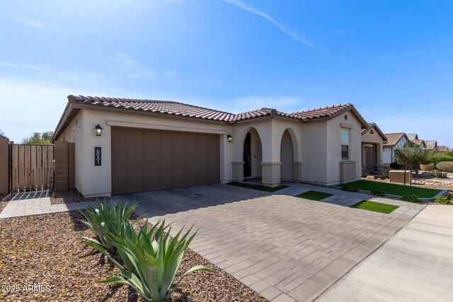 6931 W Spur Dr, Peoria, AZ 85383 - mediterranean / spanish-style home with an attached garage, stucco siding, driveway, and a tile roof