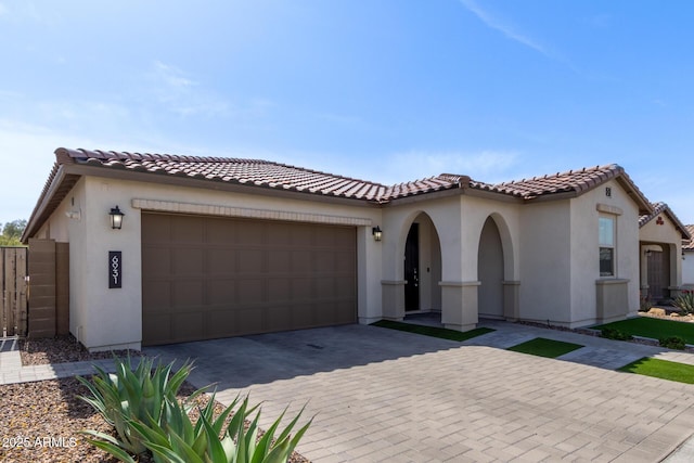 6931 W Spur Dr, Peoria, AZ 85383 - mediterranean / spanish-style house with an attached garage, decorative driveway, stucco siding, and a tiled roof