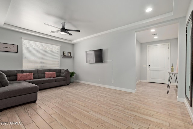6931 W Spur Dr, Peoria, AZ 85383 - living room with ceiling fan, light wood-type flooring, a tray ceiling, baseboards, and recessed lighting