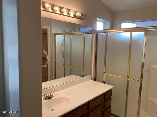 4533 E Glenhaven Dr, Phoenix, AZ 85048 - bathroom with vanity, a shower stall, and vaulted ceiling