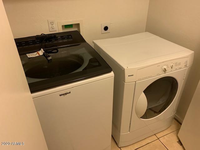 4533 E Glenhaven Dr, Phoenix, AZ 85048 - laundry room featuring washing machine and clothes dryer and light tile patterned flooring