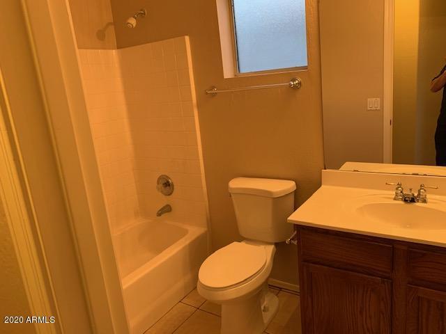 4533 E Glenhaven Dr, Phoenix, AZ 85048 - bathroom featuring vanity, toilet, tile patterned floors, and tub / shower combination
