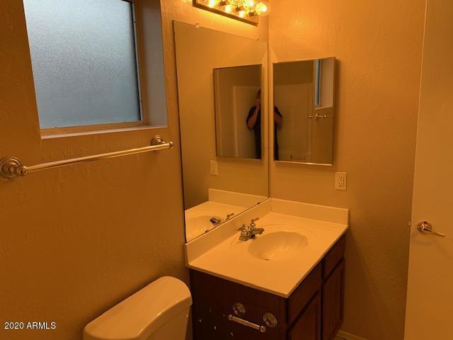 4533 E Glenhaven Dr, Phoenix, AZ 85048 - half bathroom with vanity and toilet