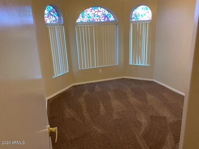 4533 E Glenhaven Dr, Phoenix, AZ 85048 - unfurnished room featuring dark colored carpet and baseboards