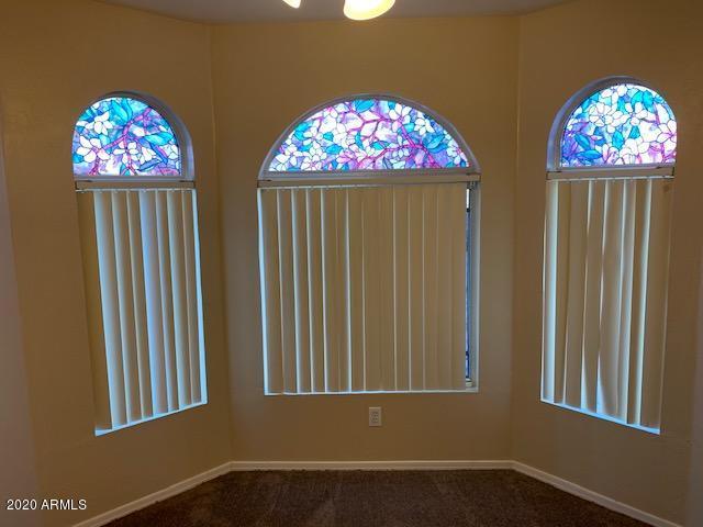4533 E Glenhaven Dr, Phoenix, AZ 85048 - carpeted spare room with plenty of natural light and baseboards
