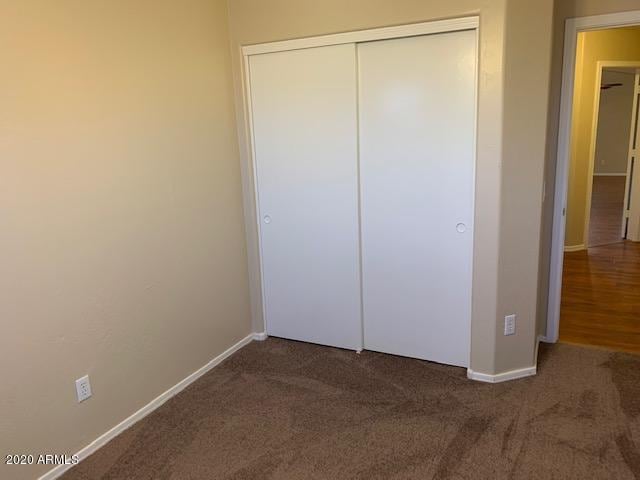 4533 E Glenhaven Dr, Phoenix, AZ 85048 - unfurnished bedroom with carpet, baseboards, and a closet