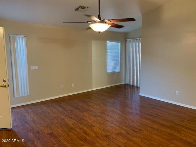 4533 E Glenhaven Dr, Phoenix, AZ 85048 - spare room with a ceiling fan, wood finished floors, and baseboards