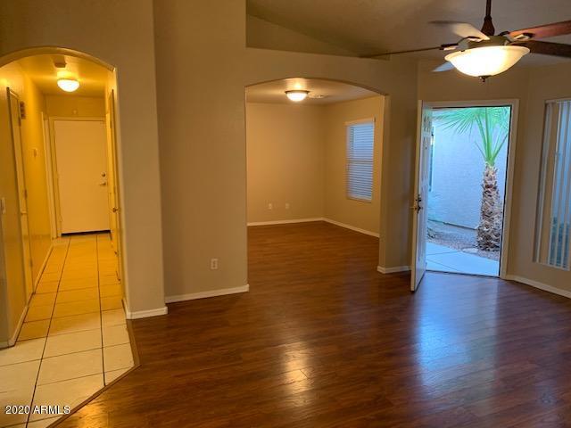 4533 E Glenhaven Dr, Phoenix, AZ 85048 - foyer entrance featuring arched walkways, a ceiling fan, wood finished floors, and baseboards