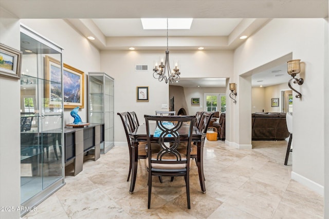 14401 N Coral Gables Dr, Phoenix, AZ 85023 - dining area with visible vents, baseboards, a raised ceiling, a chandelier, and a high ceiling