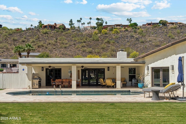 14401 N Coral Gables Dr, Phoenix, AZ 85023 - back of house with ceiling fan, outdoor lounge area, french doors, a chimney, and a yard