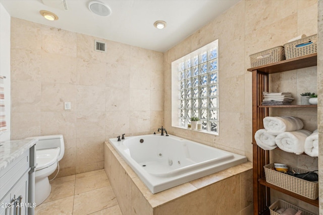 14401 N Coral Gables Dr, Phoenix, AZ 85023 - bathroom featuring tile patterned flooring, visible vents, toilet, tile walls, and a jetted tub