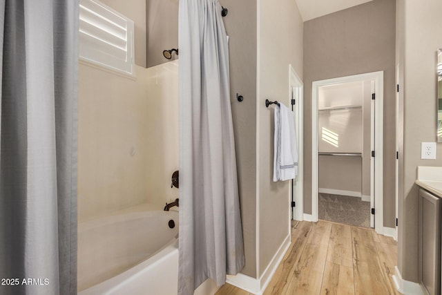 bathroom with shower / tub combo with curtain and hardwood / wood-style flooring