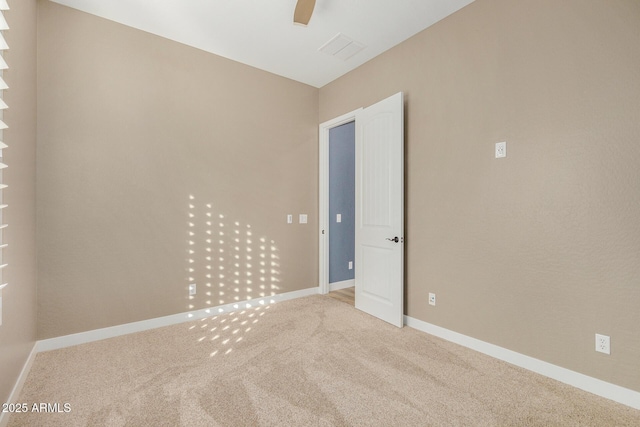 empty room with carpet flooring and ceiling fan