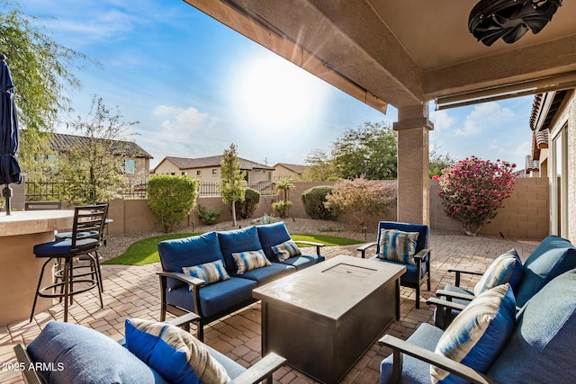 view of patio / terrace with an outdoor living space, an outdoor bar, and ceiling fan