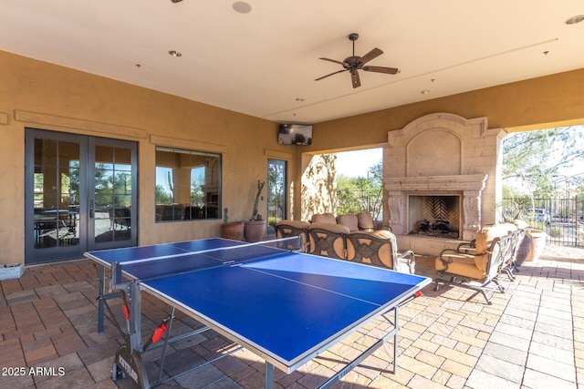 view of patio / terrace with french doors and exterior fireplace