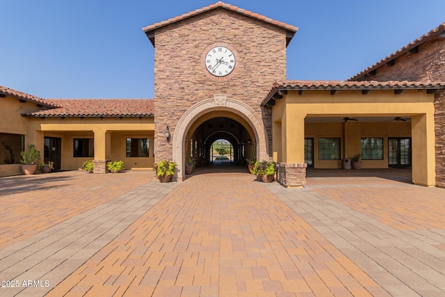 exterior space with ceiling fan