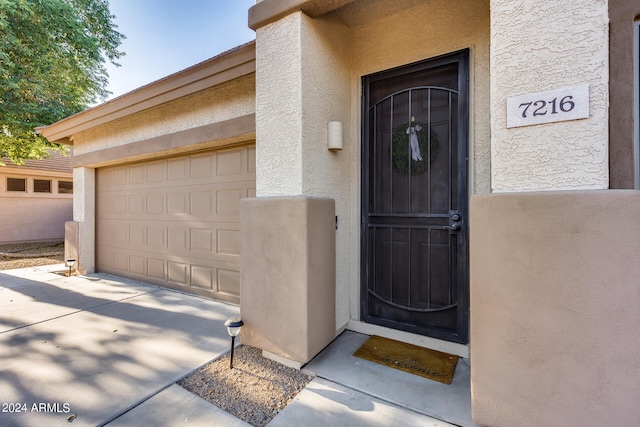 view of exterior entry featuring a garage