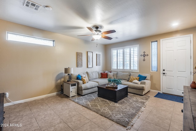 tiled living room with ceiling fan