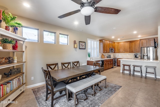 tiled dining room featuring ceiling fan