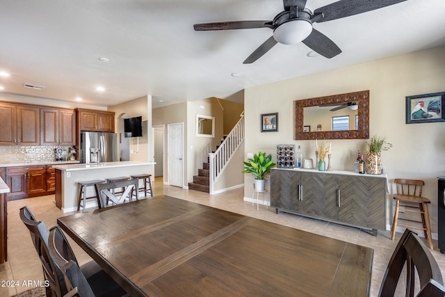 tiled dining area with ceiling fan