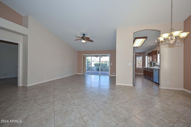 unfurnished living room with light tile patterned floors, ceiling fan with notable chandelier, and vaulted ceiling