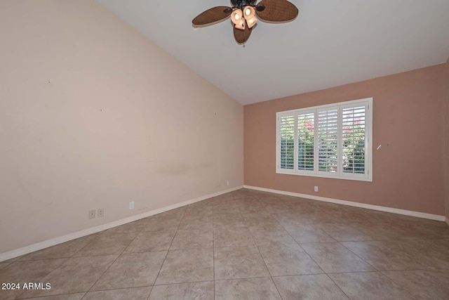 spare room featuring ceiling fan, light tile patterned floors, and lofted ceiling