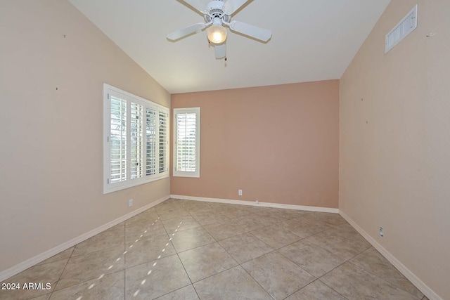 tiled spare room featuring ceiling fan and lofted ceiling