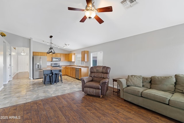 3586 S Moccasin Trl, Gilbert, AZ 85297 - living room featuring vaulted ceiling, baseboards, ceiling fan, light wood finished floors, and rail lighting