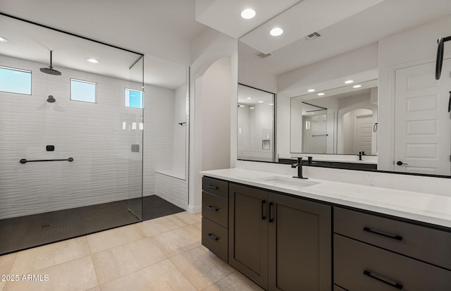 full bathroom with vanity, walk in shower, visible vents, and recessed lighting