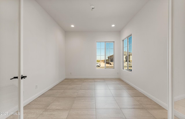 empty room with recessed lighting, light tile patterned flooring, and baseboards