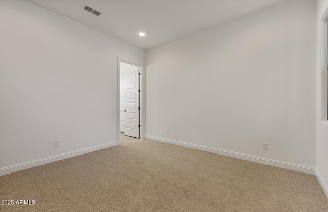 spare room featuring recessed lighting, light carpet, visible vents, and baseboards