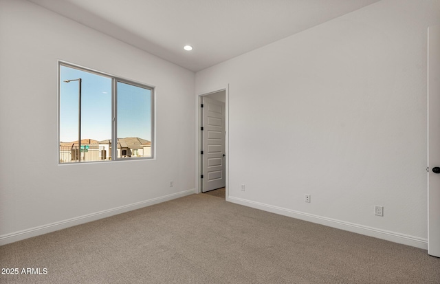 carpeted empty room featuring recessed lighting and baseboards