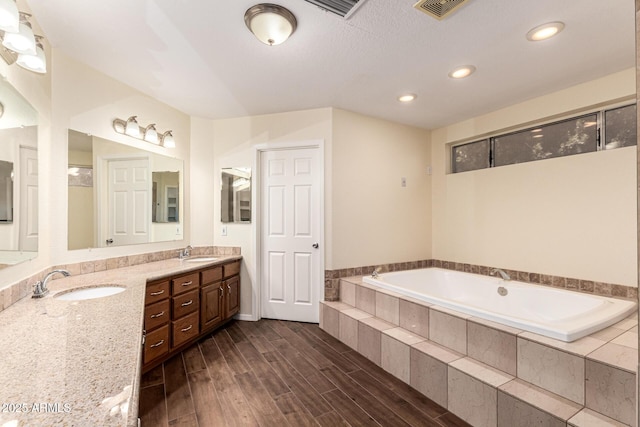 937 N Marble St, Gilbert, AZ 85234 - bathroom with a bath, double vanity, wood finished floors, and recessed lighting