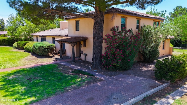 1565 E 12th St, Douglas, AZ 85607 - mediterranean / spanish-style home with a tiled roof, a front lawn, and stucco siding